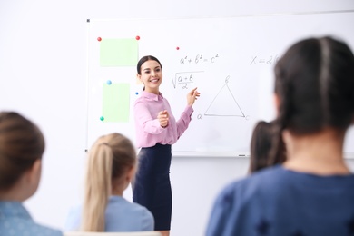 Young teacher and students in modern classroom