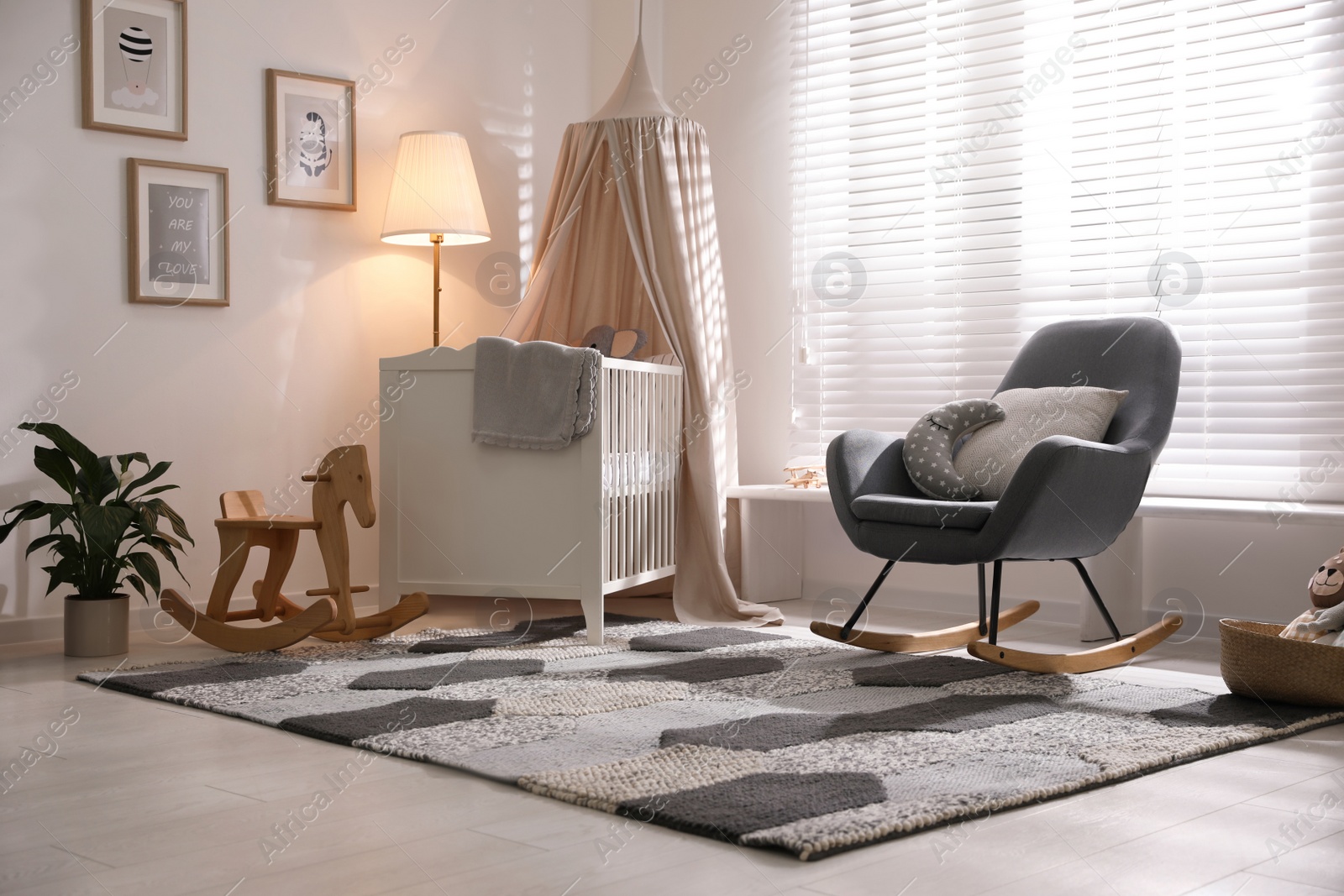 Photo of Baby room interior with comfortable crib and rocking chair