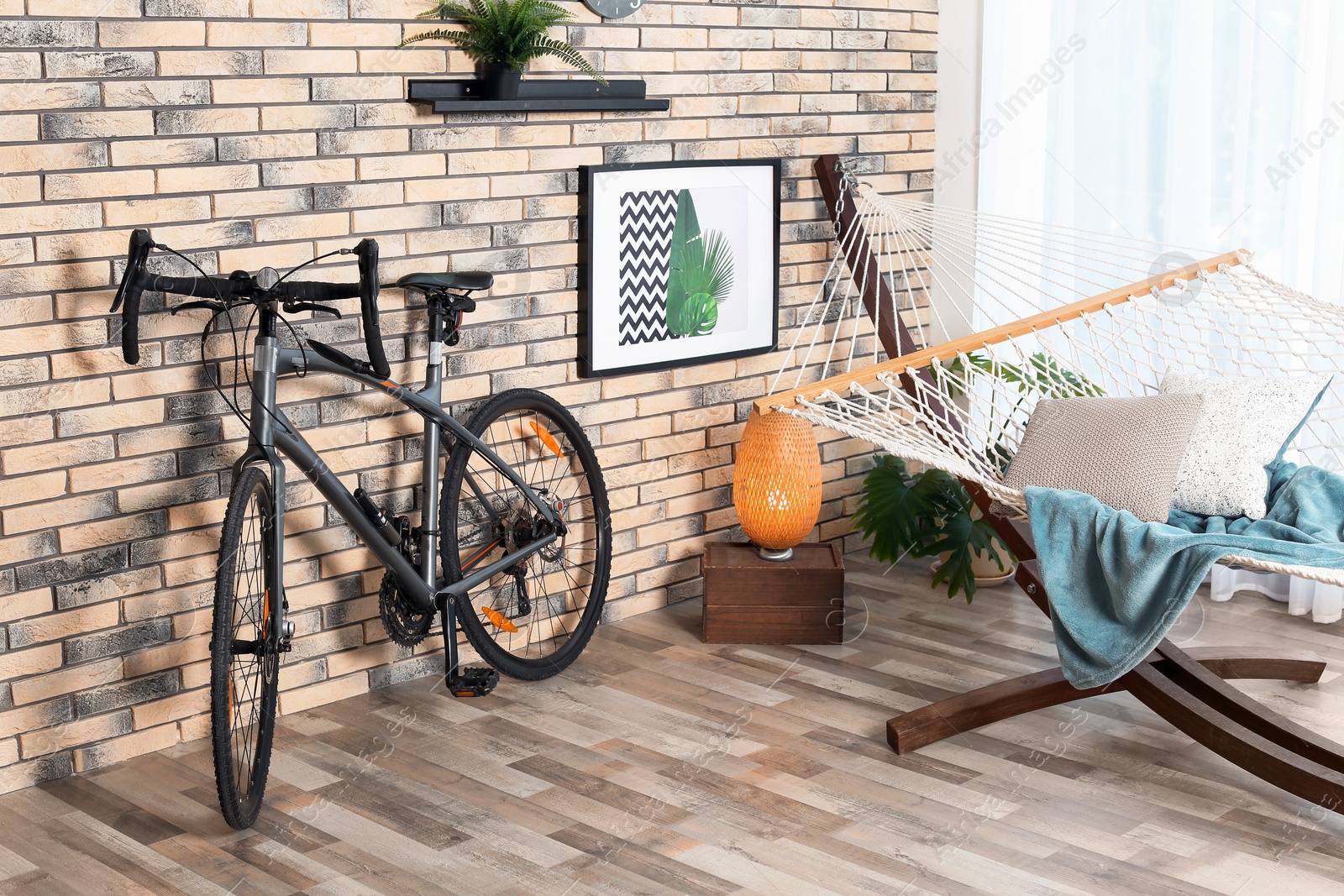 Photo of Modern bicycle and hammock in stylish room interior