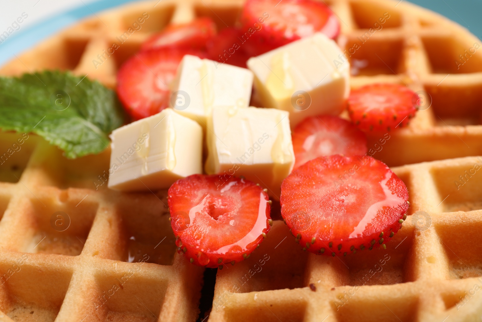Photo of Tasty Belgian waffle with strawberries, cheese and honey, closeup