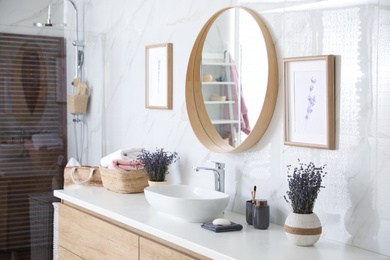 Mirror and counter with vessel sink in stylish bathroom interior. Idea for design