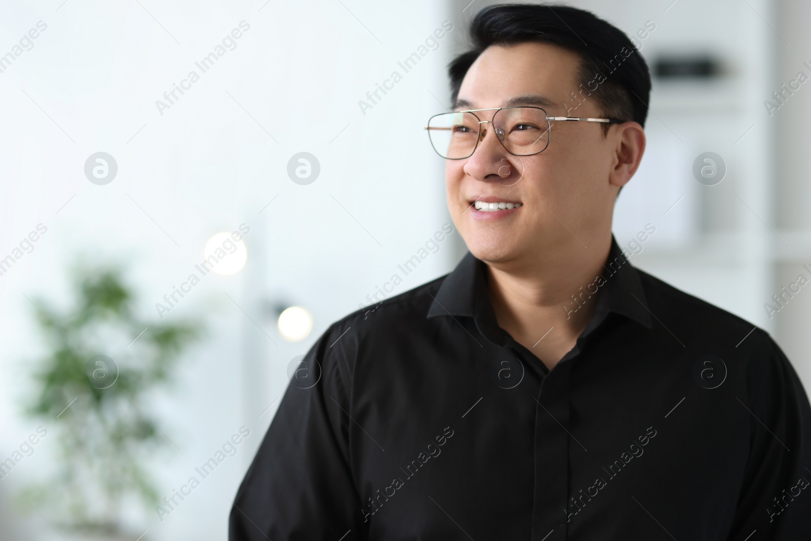 Photo of Portrait of smiling businessman in office. Space for text