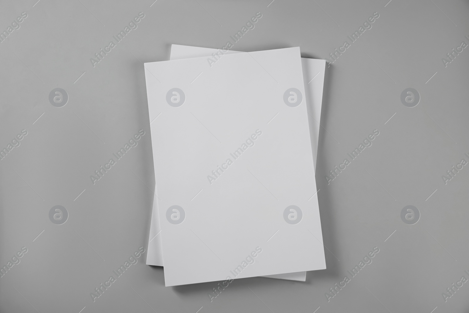 Photo of Blank brochures on grey background, top view. Mockup for design
