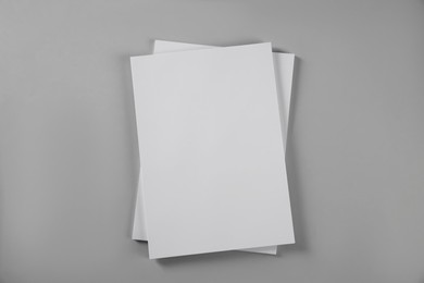 Photo of Blank brochures on grey background, top view. Mockup for design