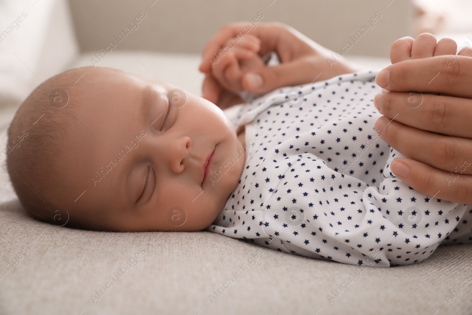 Photo of Mother with her cute sleeping baby at home, closeup