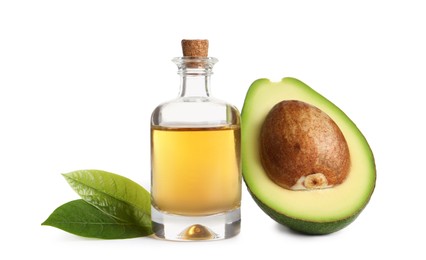 Bottle of essential oil, avocado and leaves on white background