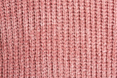 Photo of Beautiful pink knitted fabric as background, top view