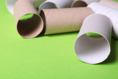 Photo of Empty toilet paper rolls on color background