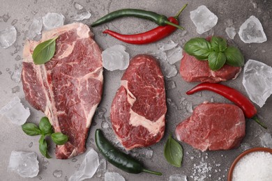 Photo of Flat lay composition with cut fresh beef meat on brown table, flat lay
