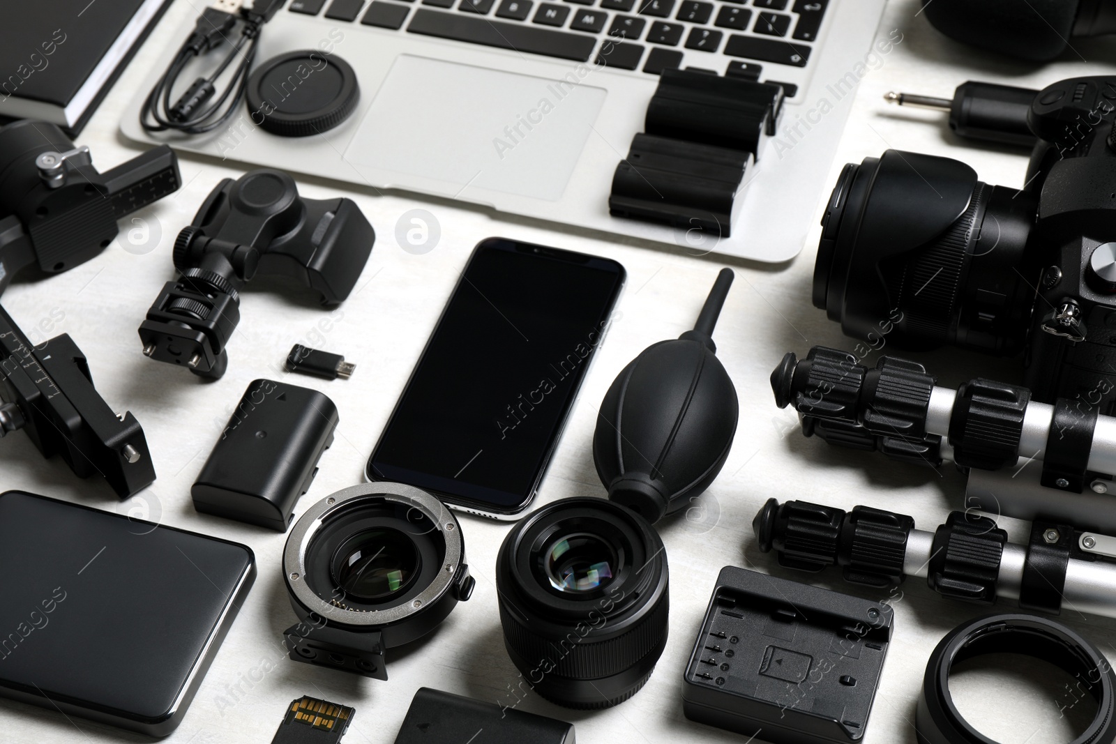 Photo of Camera equipment and accessories for video production on light background