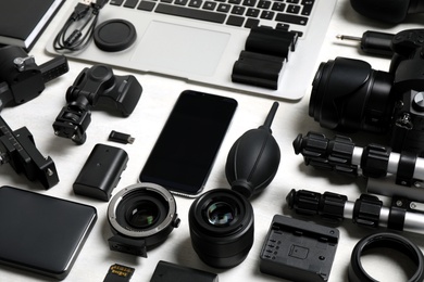 Photo of Camera equipment and accessories for video production on light background