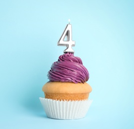 Photo of Birthday cupcake with number four candle on blue background