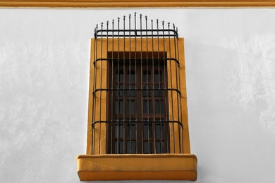 Photo of Exterior of building with beautiful window and steel grilles