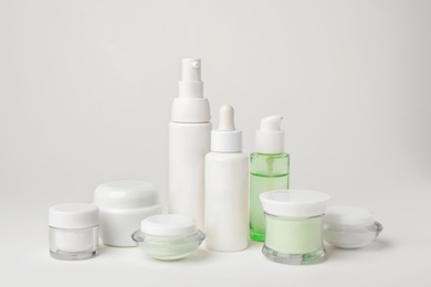 Photo of Composition with cosmetic products on light background