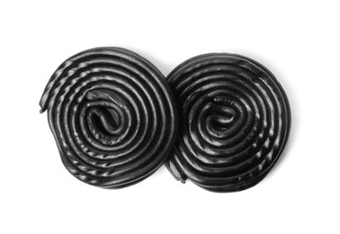 Photo of Tasty black liquorice candies on white background, top view