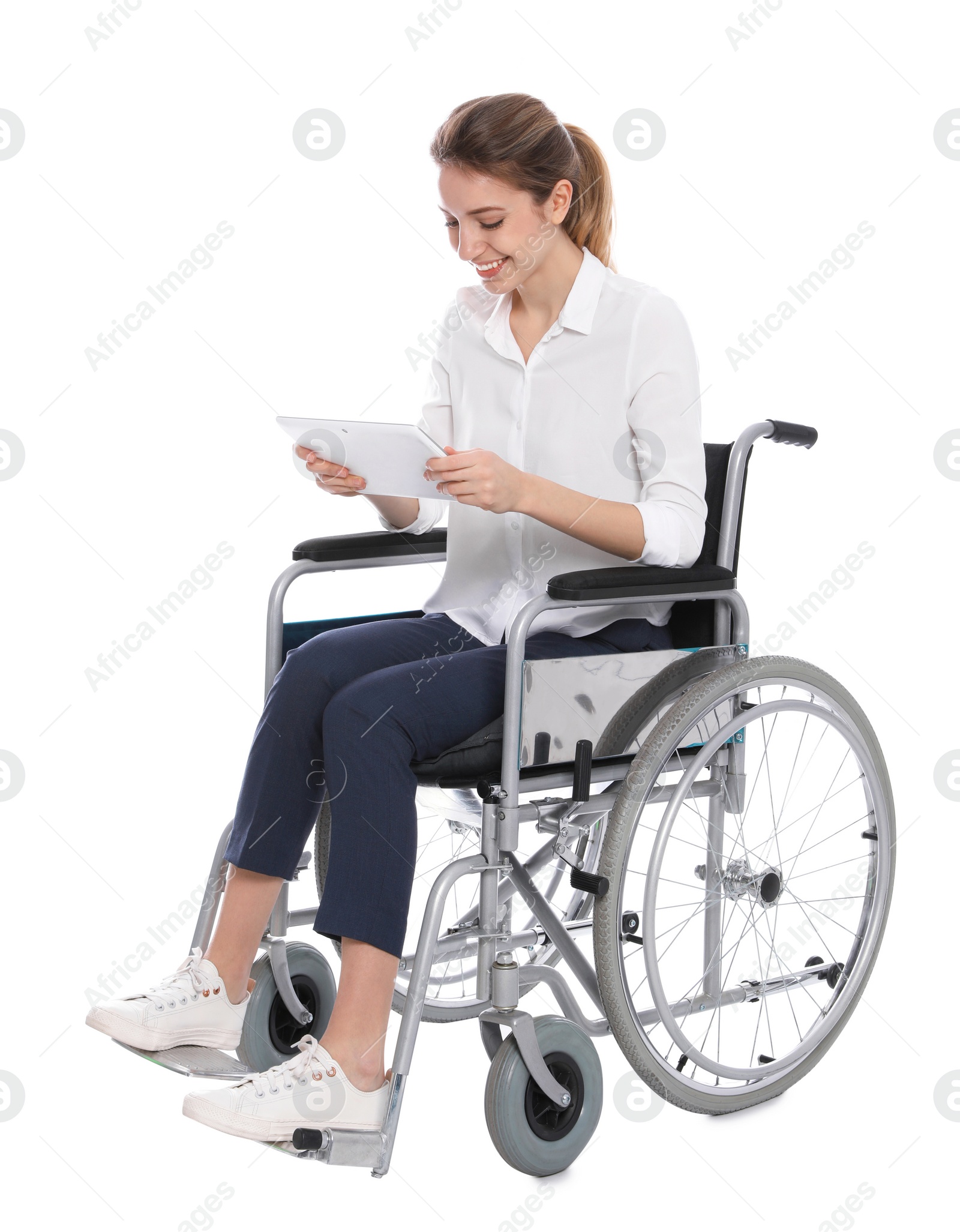 Photo of Young woman in wheelchair using tablet isolated on white