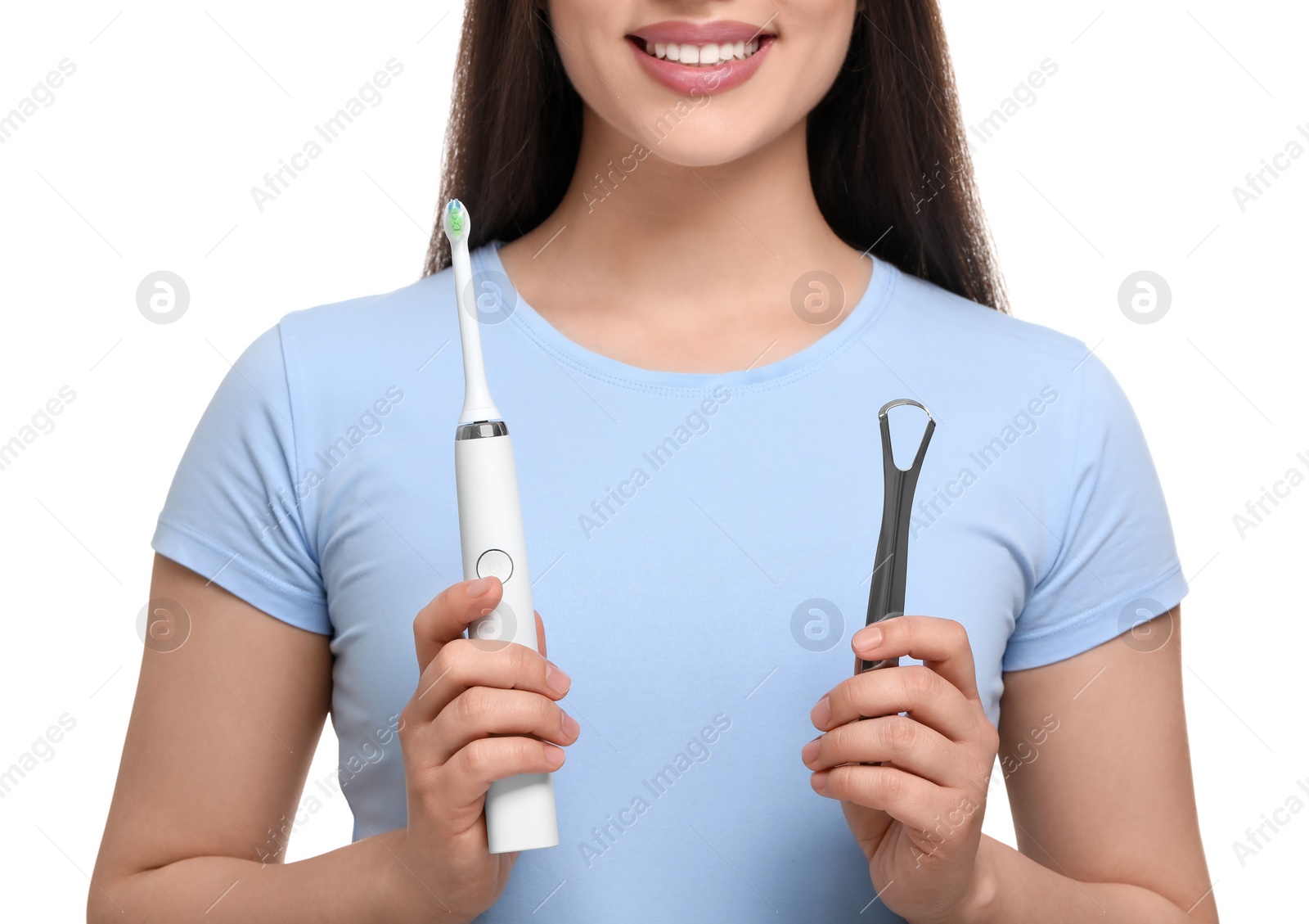 Photo of Woman with tongue cleaner and electric toothbrush on white background, closeup