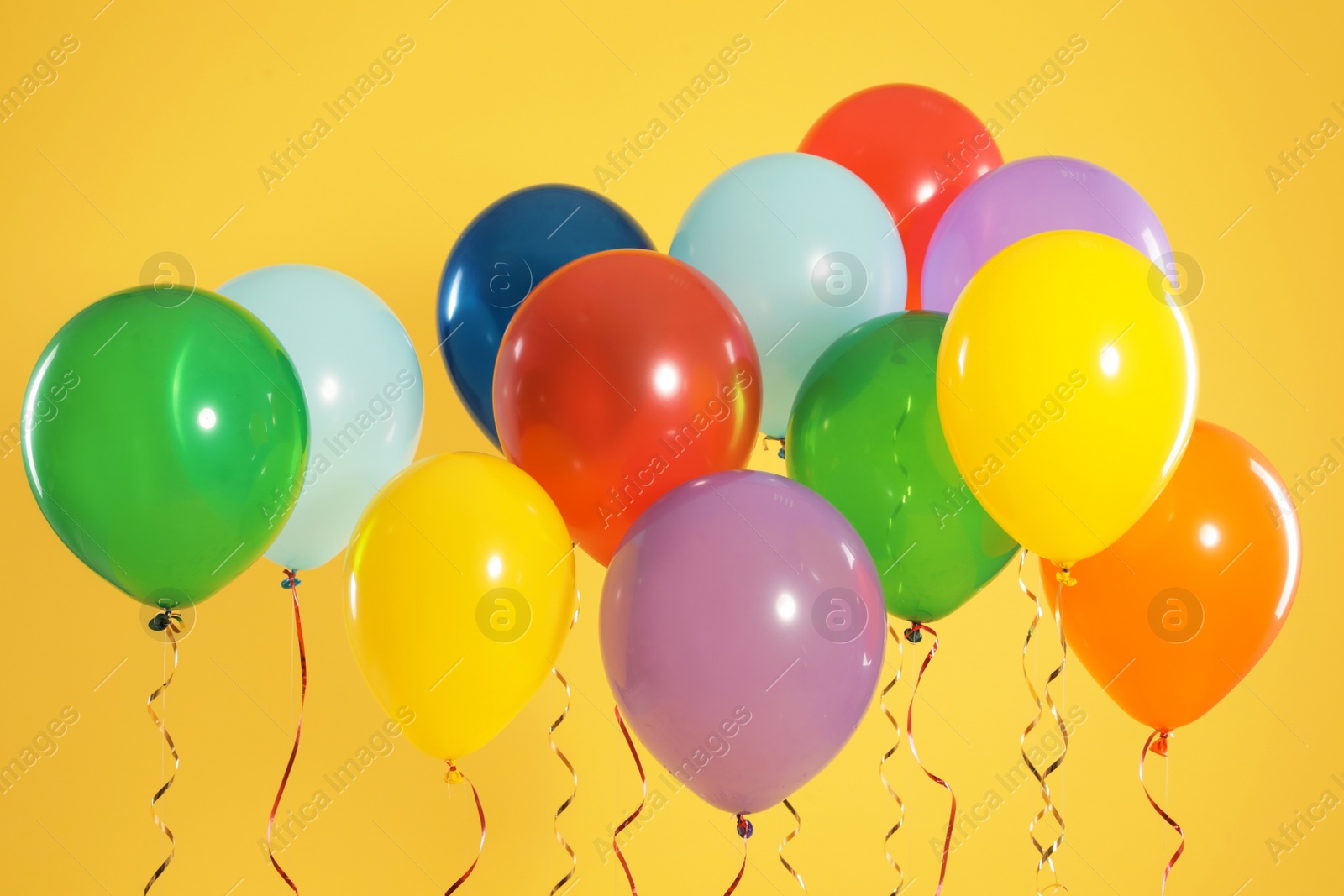 Photo of Bright balloons on color background. Celebration time