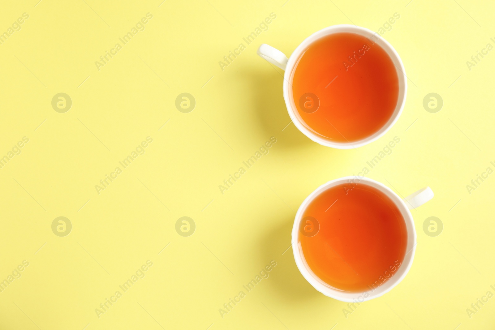 Photo of Cups of delicious tea on color background, top view