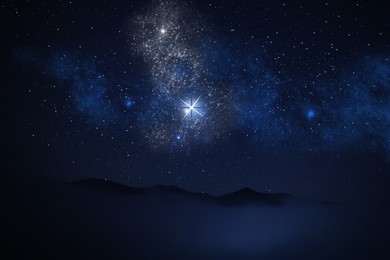 Image of Misty mountains under starry sky at night