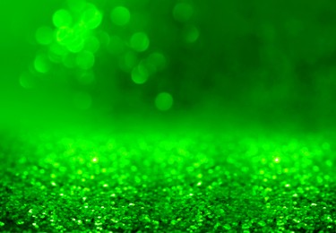 Image of St. Patrick day. Shiny green glitter, closeup. Bokeh effect