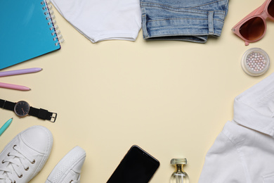 Photo of Frame made of stylish clothes and accessories on beige background, flat lay. Space for text