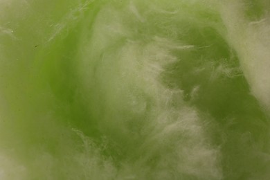Photo of Green cotton candy as background, closeup view