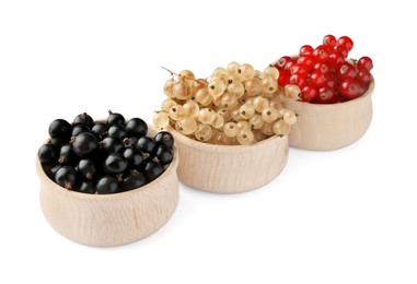 Photo of Fresh red, white and black currants in bowls isolated on white