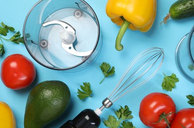 Hand blender kit and fresh products on light blue background, flat lay