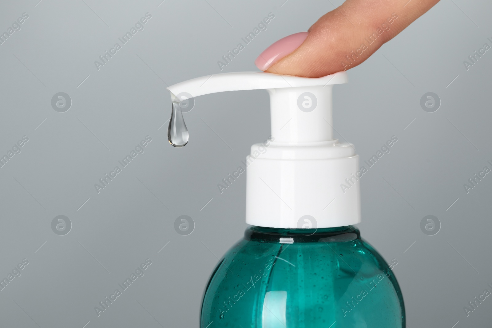Photo of Woman using cleansing gel on dusty light blue background, closeup. Space for text