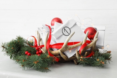 Photo of Paper bags and festive decor on light table. Christmas advent calendar