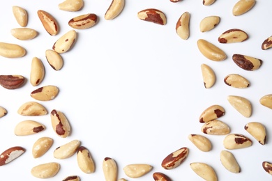 Photo of Composition with Brazil nuts and space for text on white background, top view