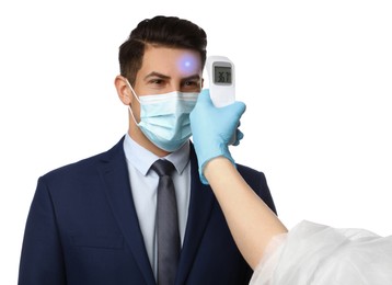 Image of Doctor measuring man's temperature on white background, closeup. Prevent spreading of Covid-19