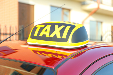 Photo of Roof light with word TAXI on car outdoors