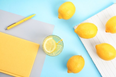 Photo of Flat lay composition with delicious natural lemonade on color background
