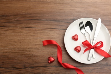 Photo of Beautiful table setting on wooden background, flat lay with space for text. Valentine's Day dinner