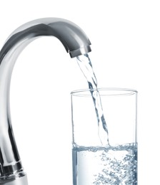 Image of Filling glass with water from tap on white background