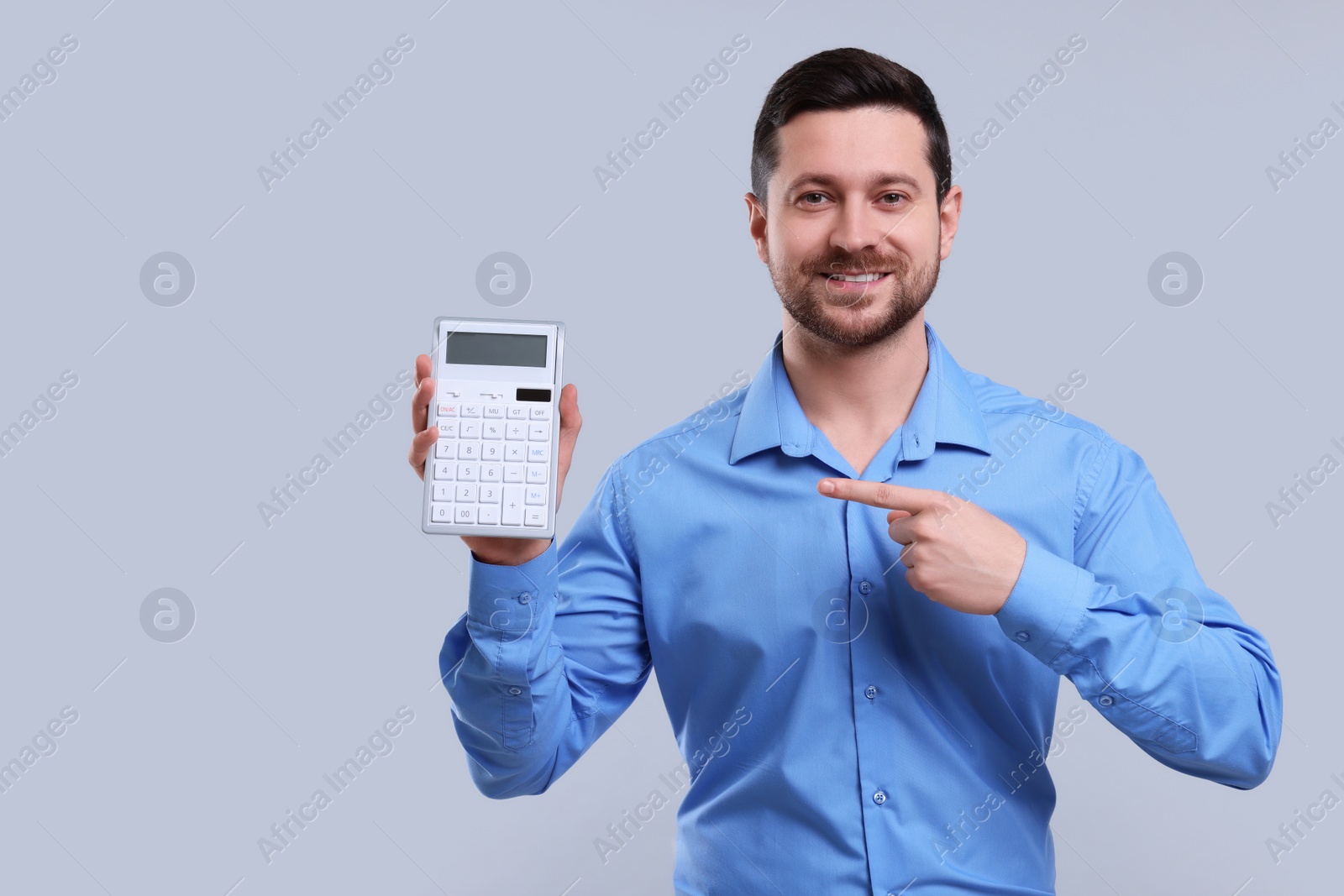 Photo of Happy accountant showing calculator on light grey background. Space for text
