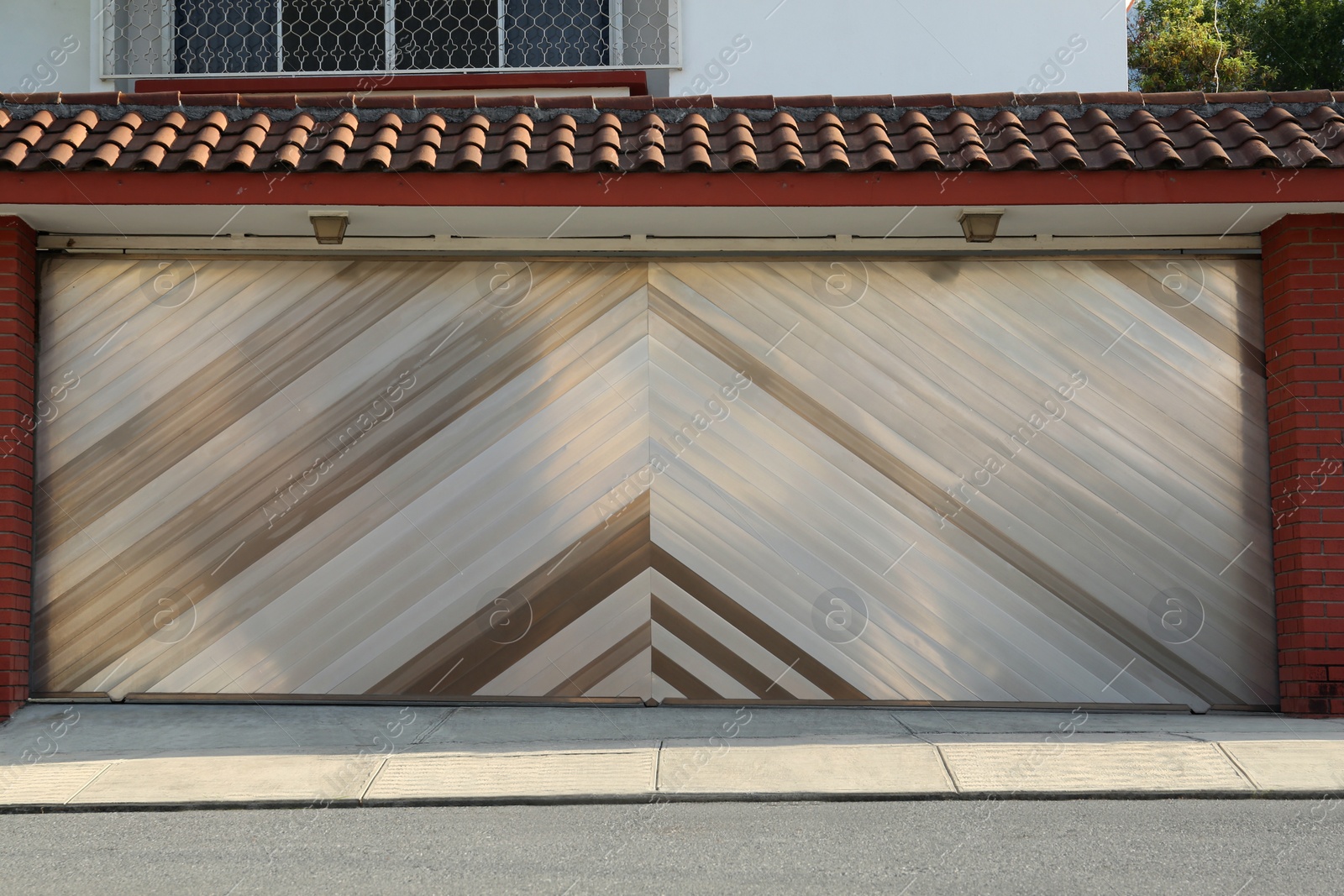 Photo of View of building with modern garage gates outdoors