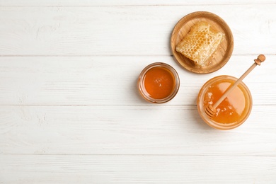 Photo of Flat lay composition with fresh honey on wooden background