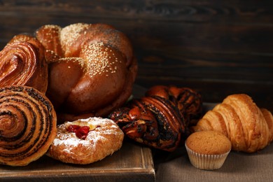 Photo of Different tasty freshly baked pastries on table