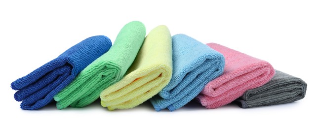 Photo of Many colorful microfiber cloths on white background