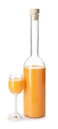 Photo of Bottle and glass with tasty tangerine liqueur isolated on white
