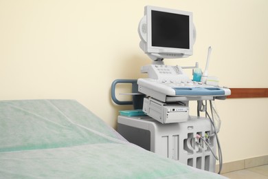 Photo of Ultrasound machine and examination table in hospital