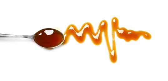 Photo of Spoon with delicious caramel sauce on white background