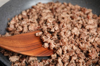 Photo of Cooking minced meat in frying pan, closeup