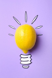 Photo of Composition with lemon as lamp bulb on violet background, top view. Creative concept