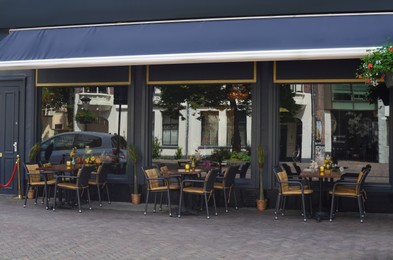 Photo of Beautiful view of outdoor cafe with stylish furniture