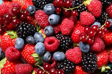 Photo of Many different fresh ripe berries as background, top view