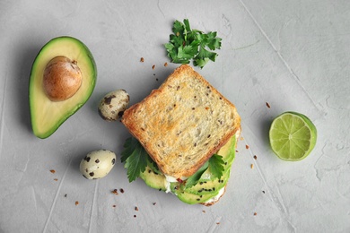 Photo of Flat lay composition with crisp toast and avocado on table